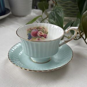 Elegant Teacup and Saucer with Fruit Design